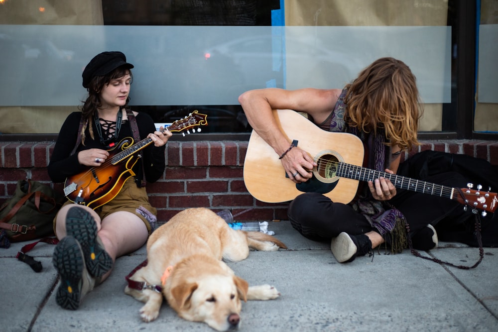 two men playing guitars