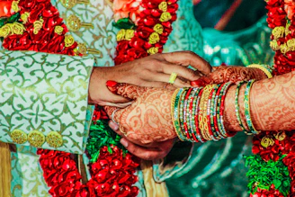 mendhi tattoo on person's hand