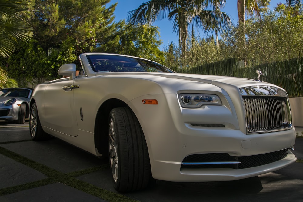 white coupe on road at daytime