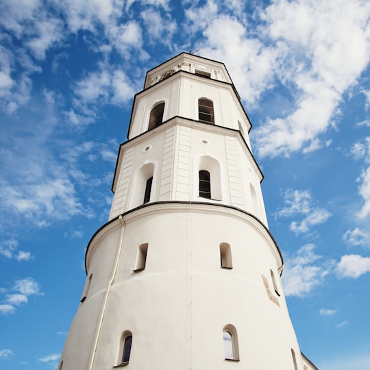 white lighthouse under blue sky in Vilnius Cathedral Lithuania