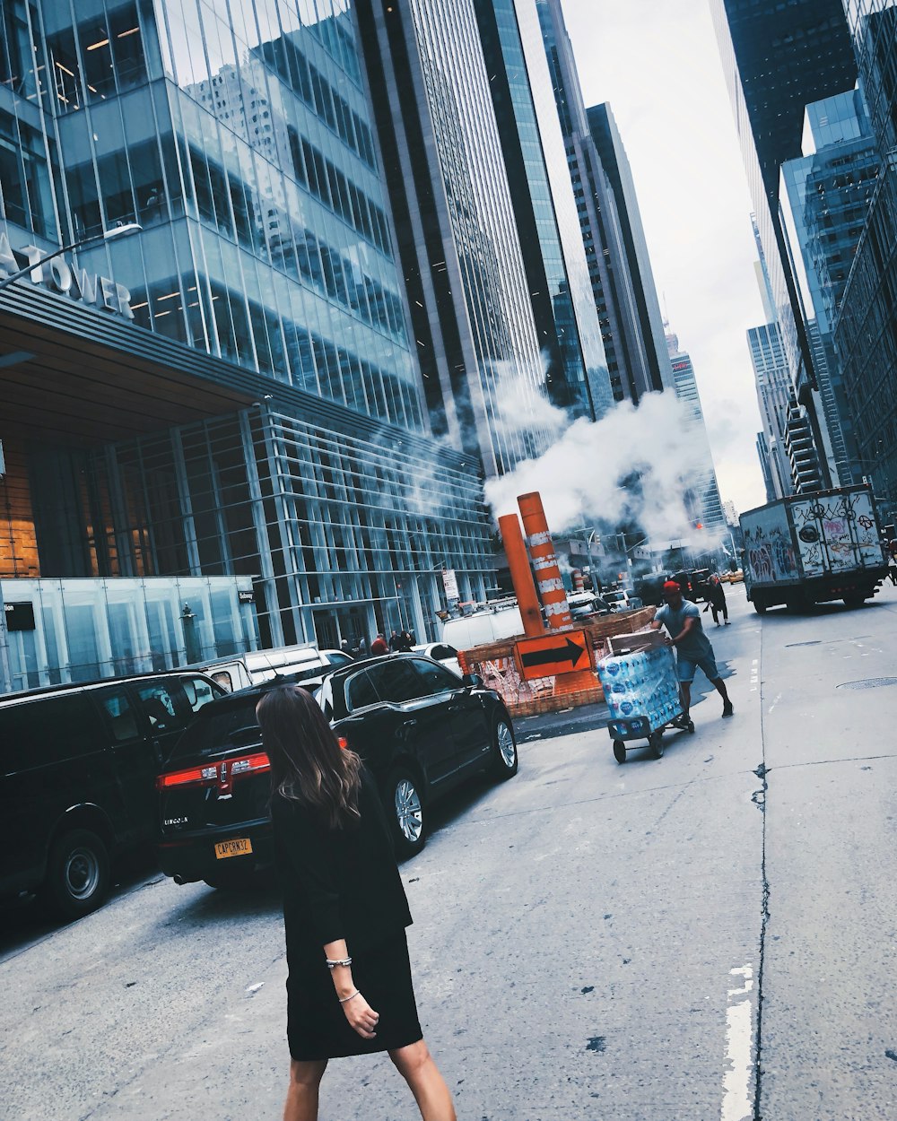 woman walking across street