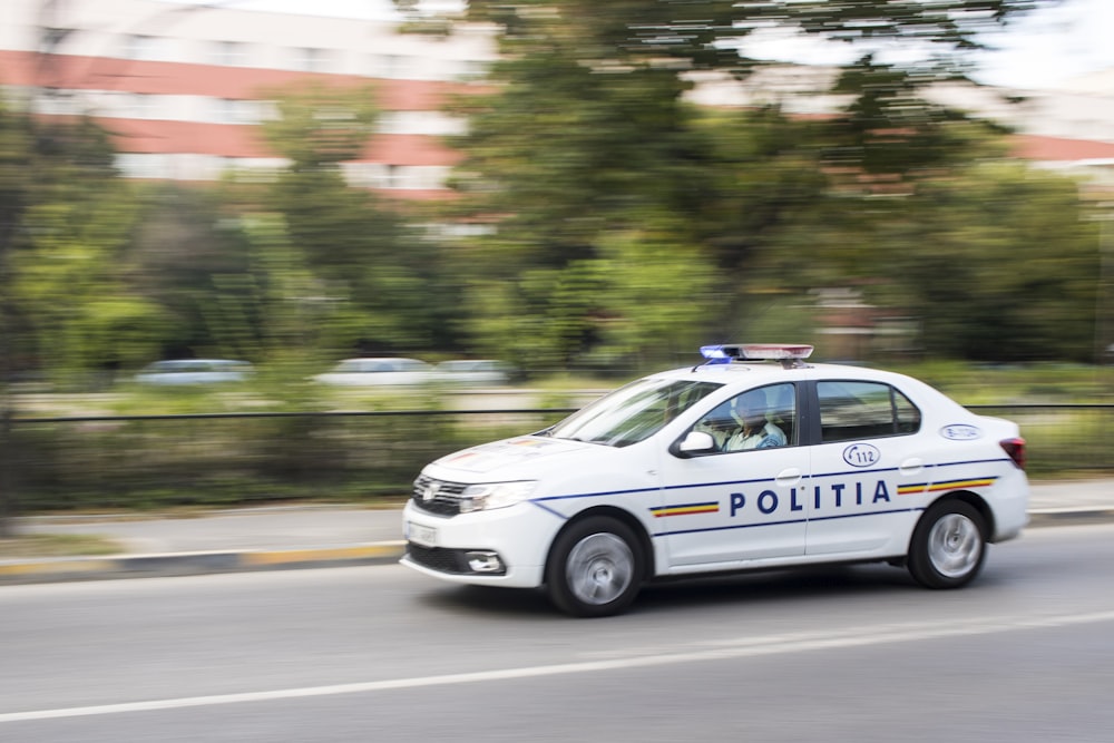 man riding police car