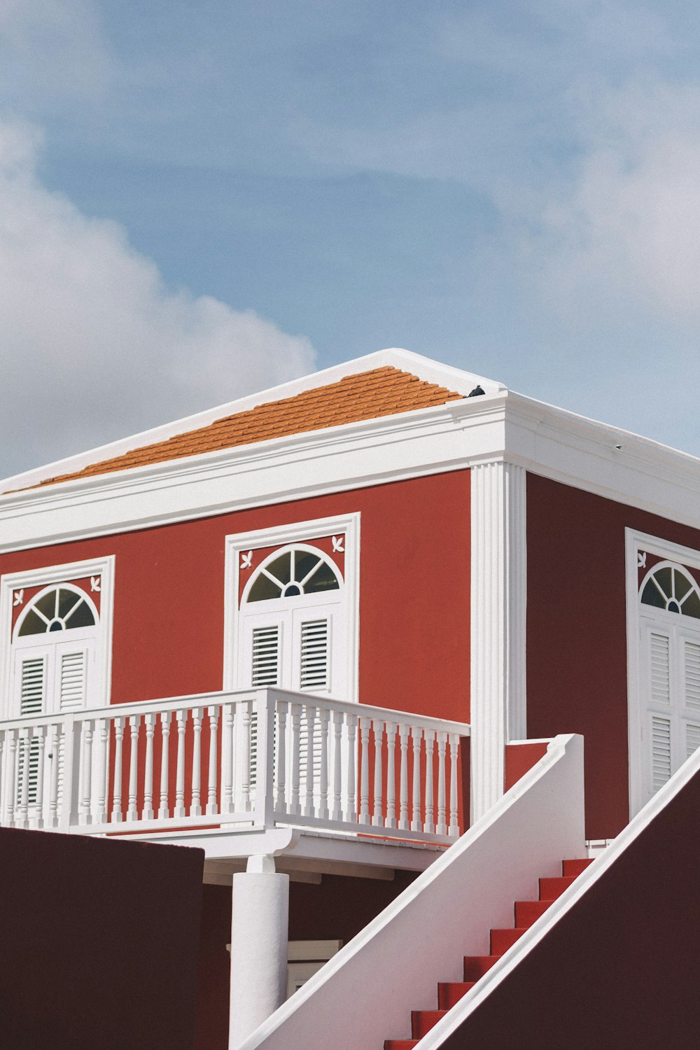 red and brown house under cloudy sky