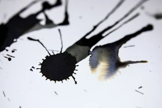 A vibrant ink splash on white canvas, showing dynamic movement and color blending