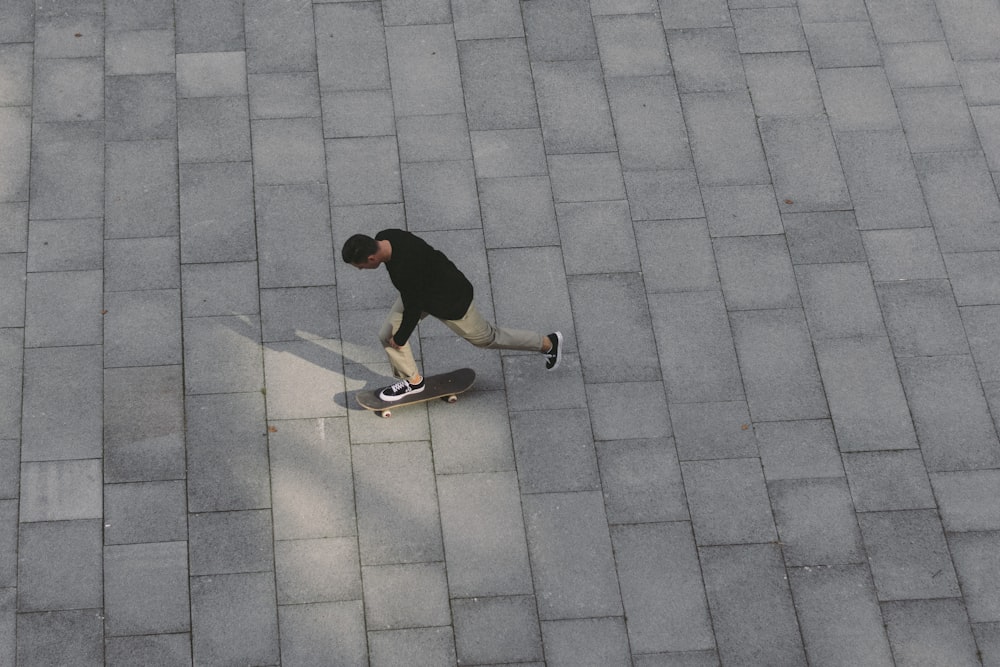 man skateboarding on concrete pavement