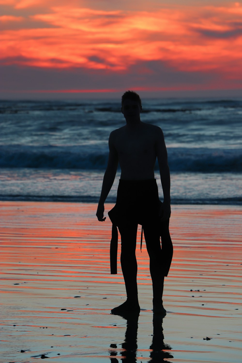 silhouette of man near ocean