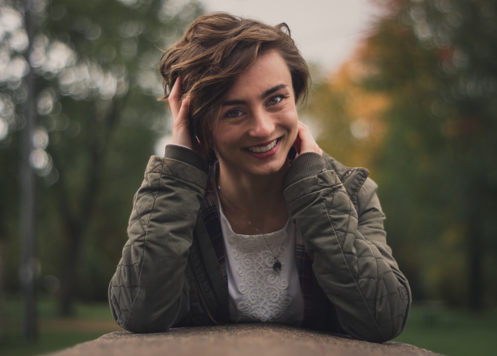 smiling woman holding her head