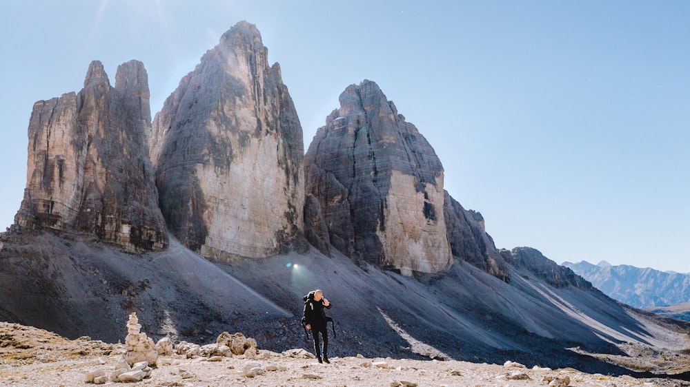 person walking near rocks