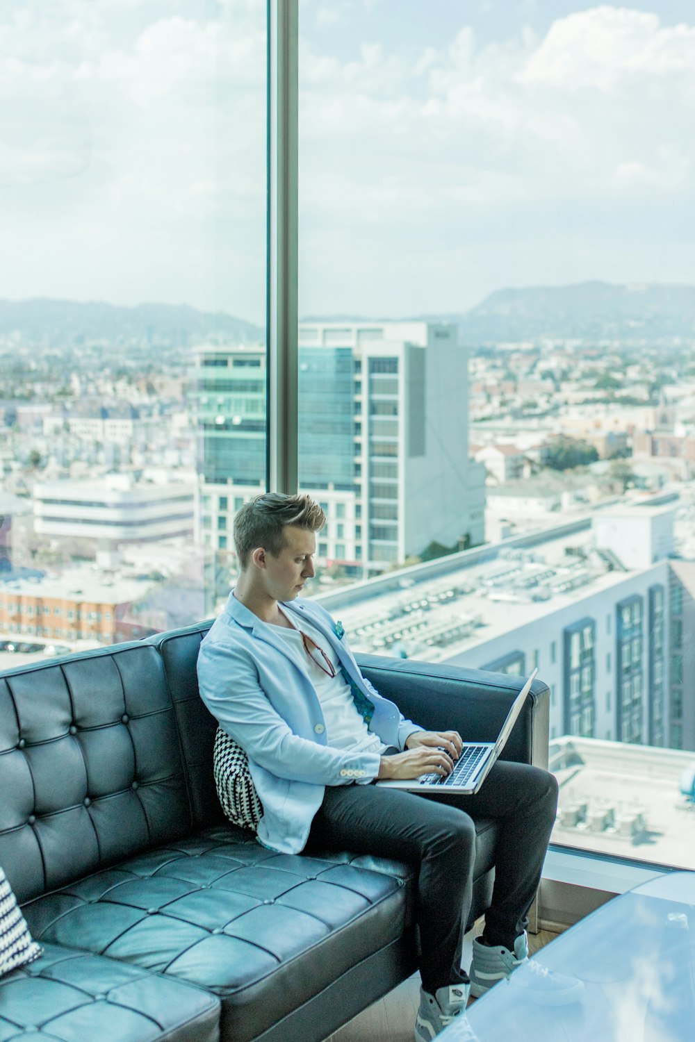 men's blue blazer sitting on sofa