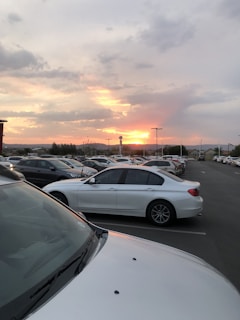 A sunset view of cars lined up at a rental lot.