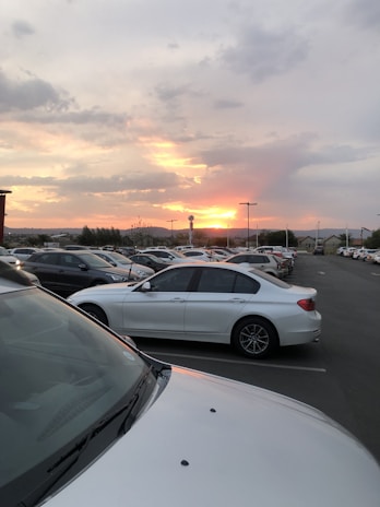 A sunset view of cars lined up at a rental lot.