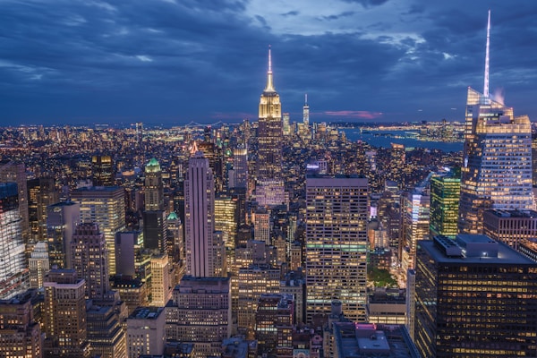 A vibrant city skyline at dusk, with glowing lights and bustling streets capturing the energy of a city break.