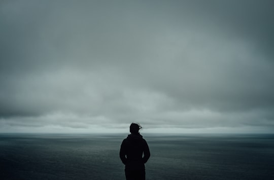 person standing near body of water in Meat Cove Canada