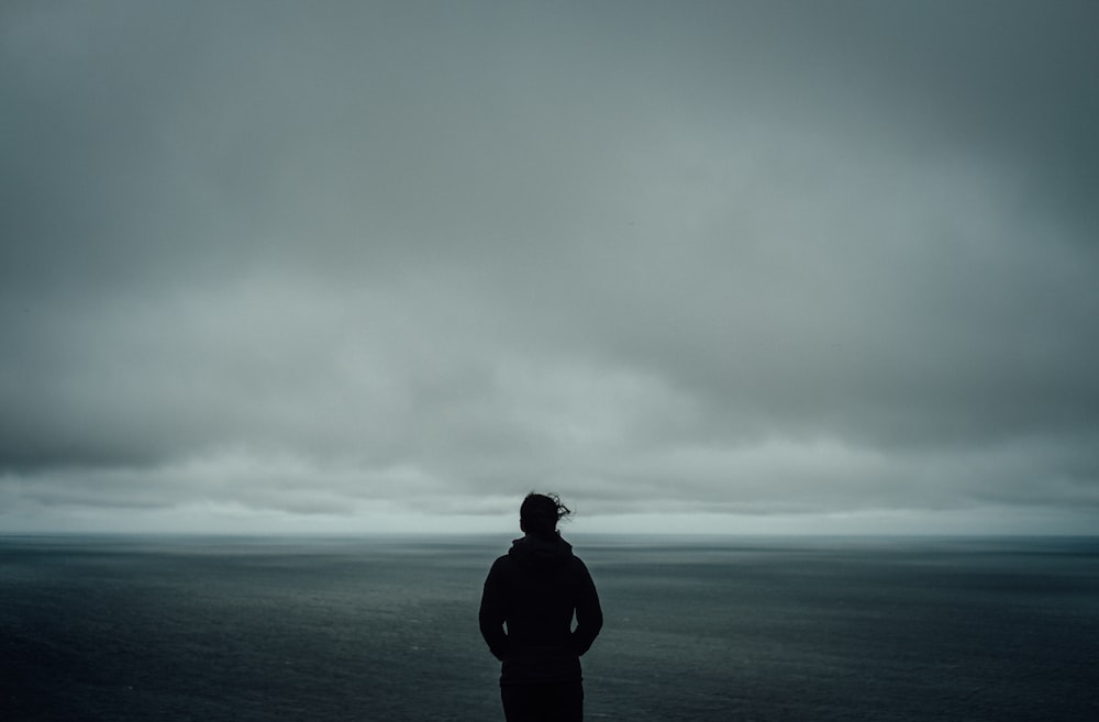 person standing near body of water