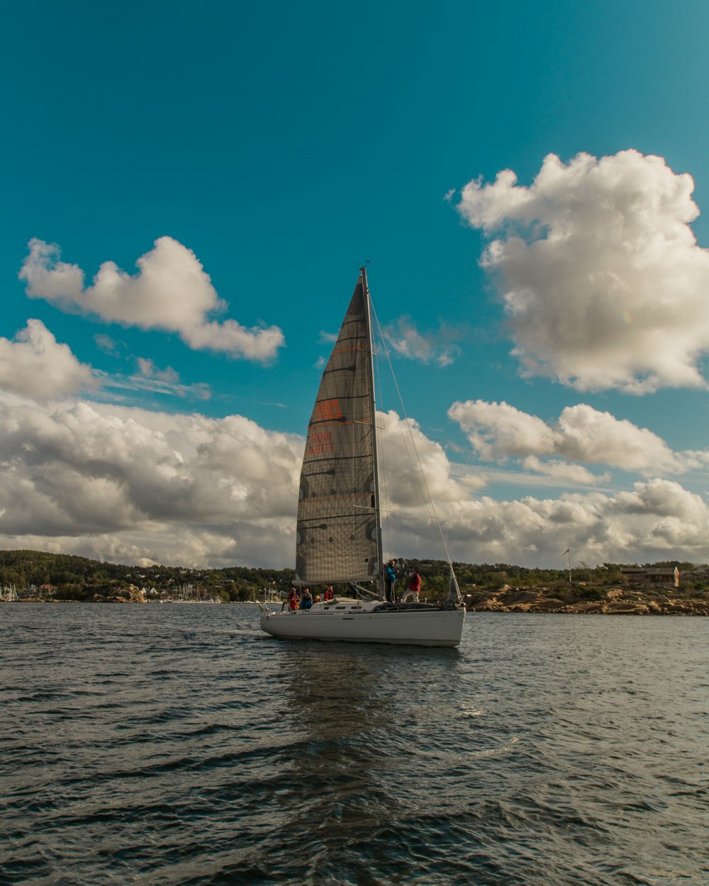 white sailboat sailing during daytime