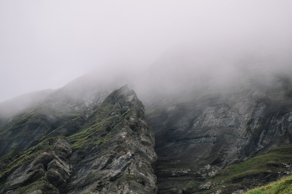 rock formation surrounded by fogs