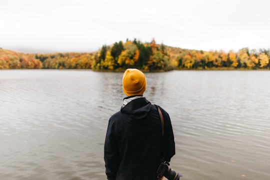 person standing facing body of water in Vermont United States