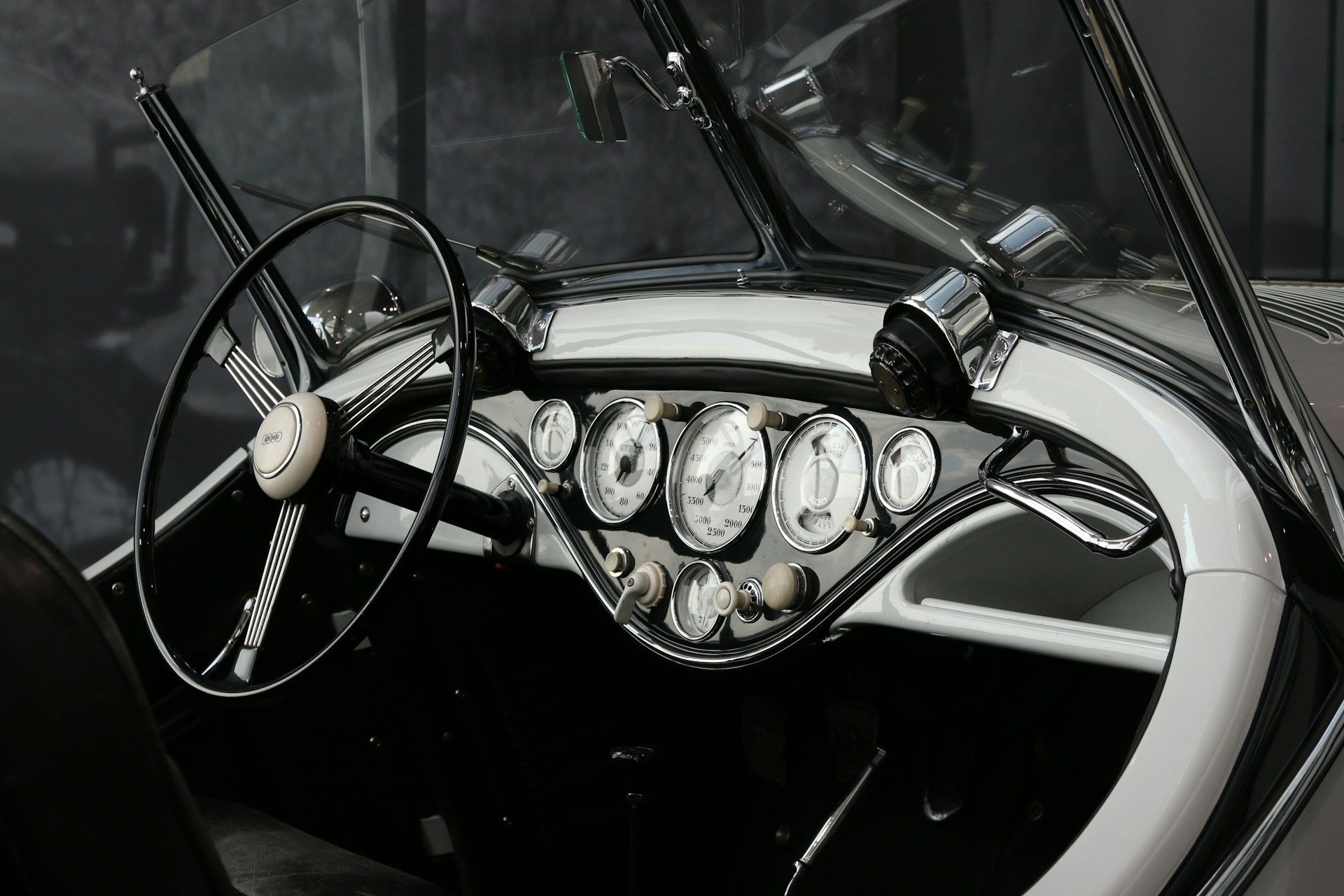 grayscale photo of vehicle steering wheel