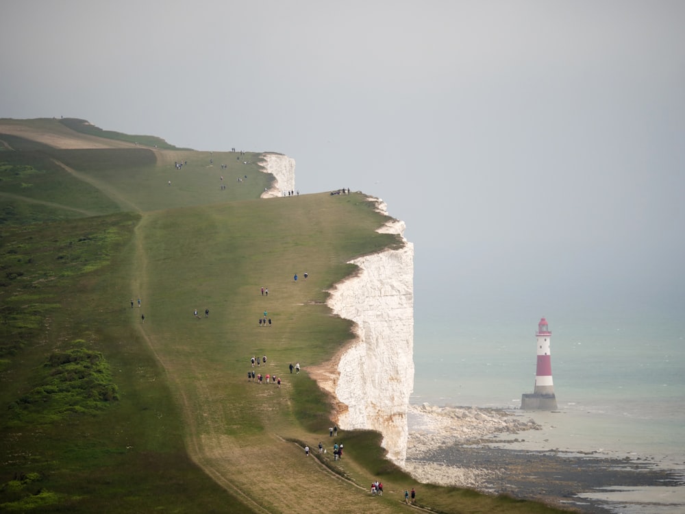 lighthouse near mountains