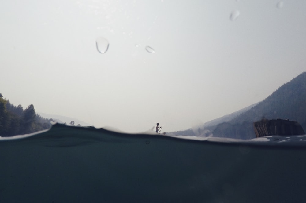 a person riding a board on top of a body of water