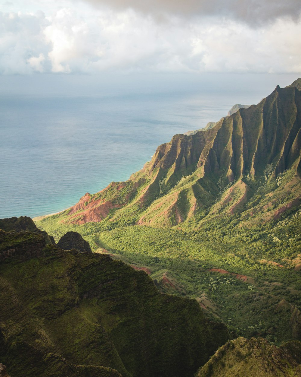 a view of a mountain range with a body of water in the distance