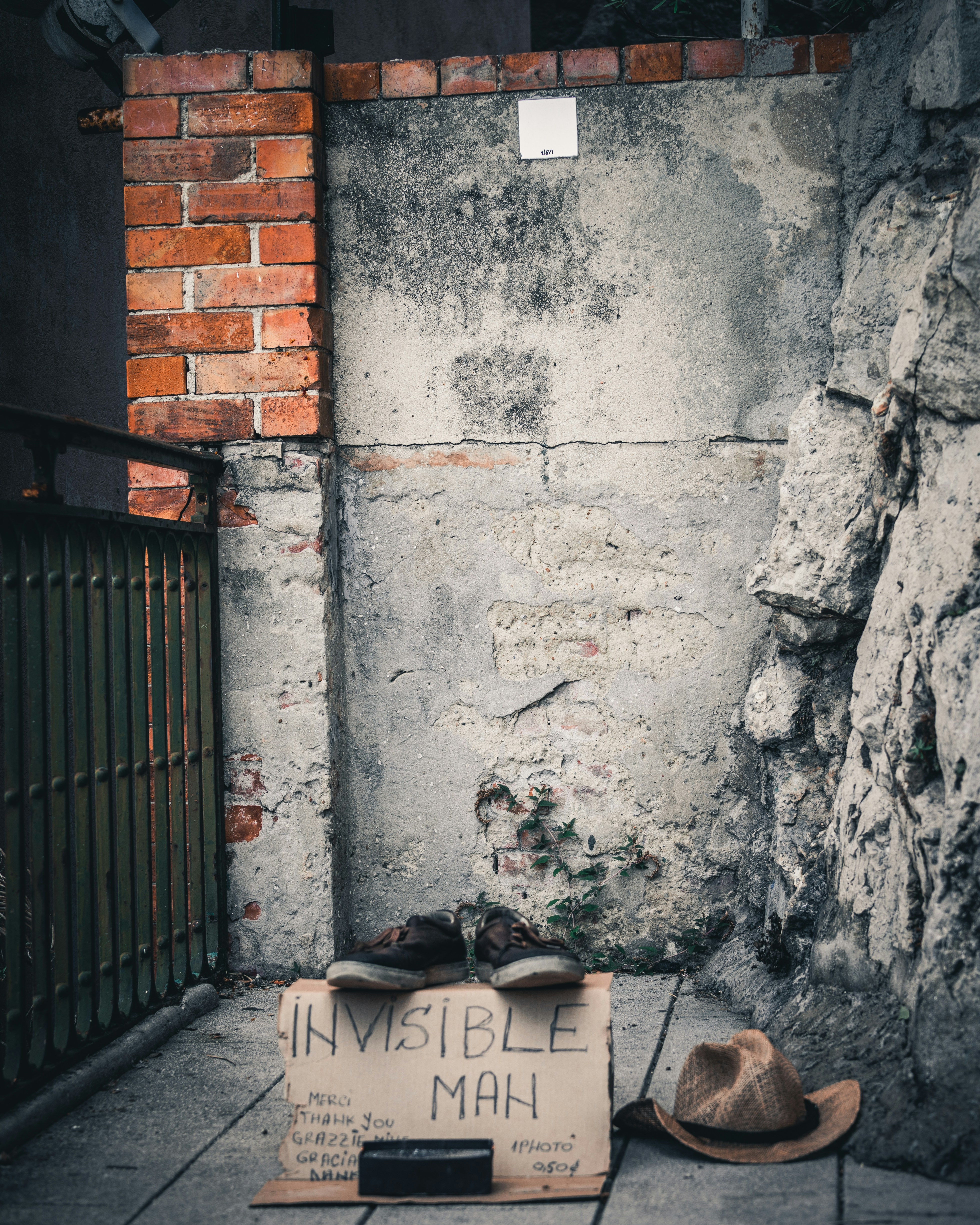 pair of shoes on cardboard signage beside brown hat