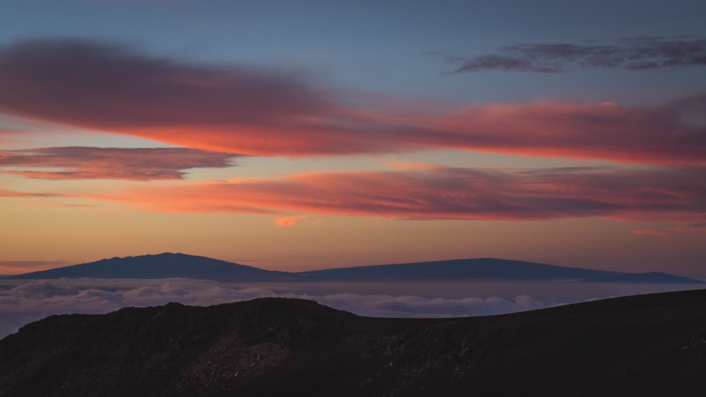 silhouette of mountain under blue sky