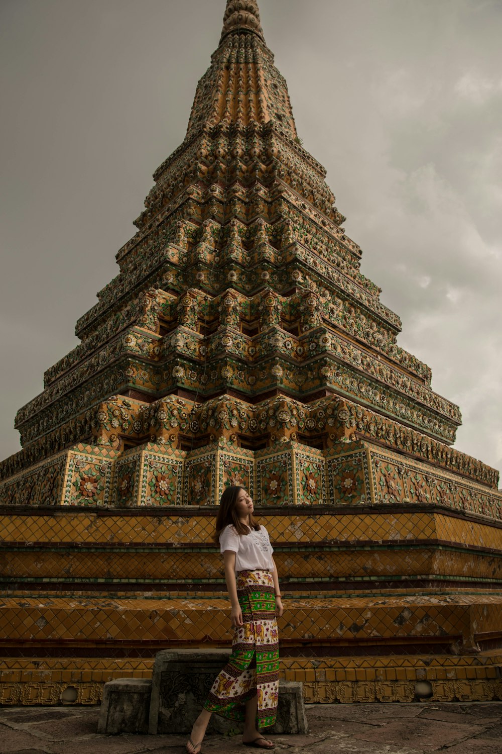 woman standing beside pagoda temple