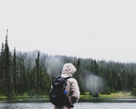A hoodie draped over a rustic bench near a foggy lake shore, capturing the calmness of the Northwest.