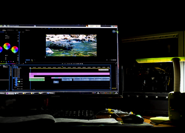 A sleek dark-themed editing suite with multiple screens showing video timelines and motion graphics.