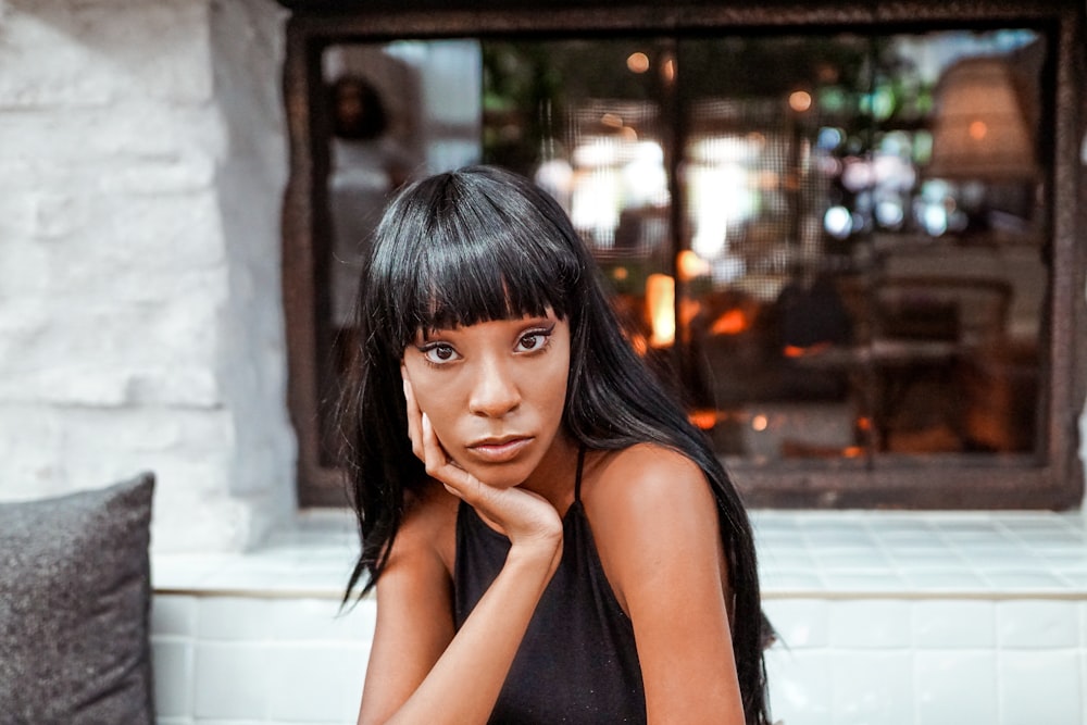 mulher vestindo o top preto do cabresto da alça do espaguete durante o dia