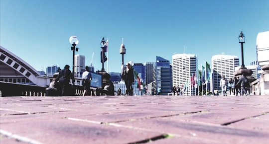 people walking on concrete road during daytime in Pyrmont Bridge Australia