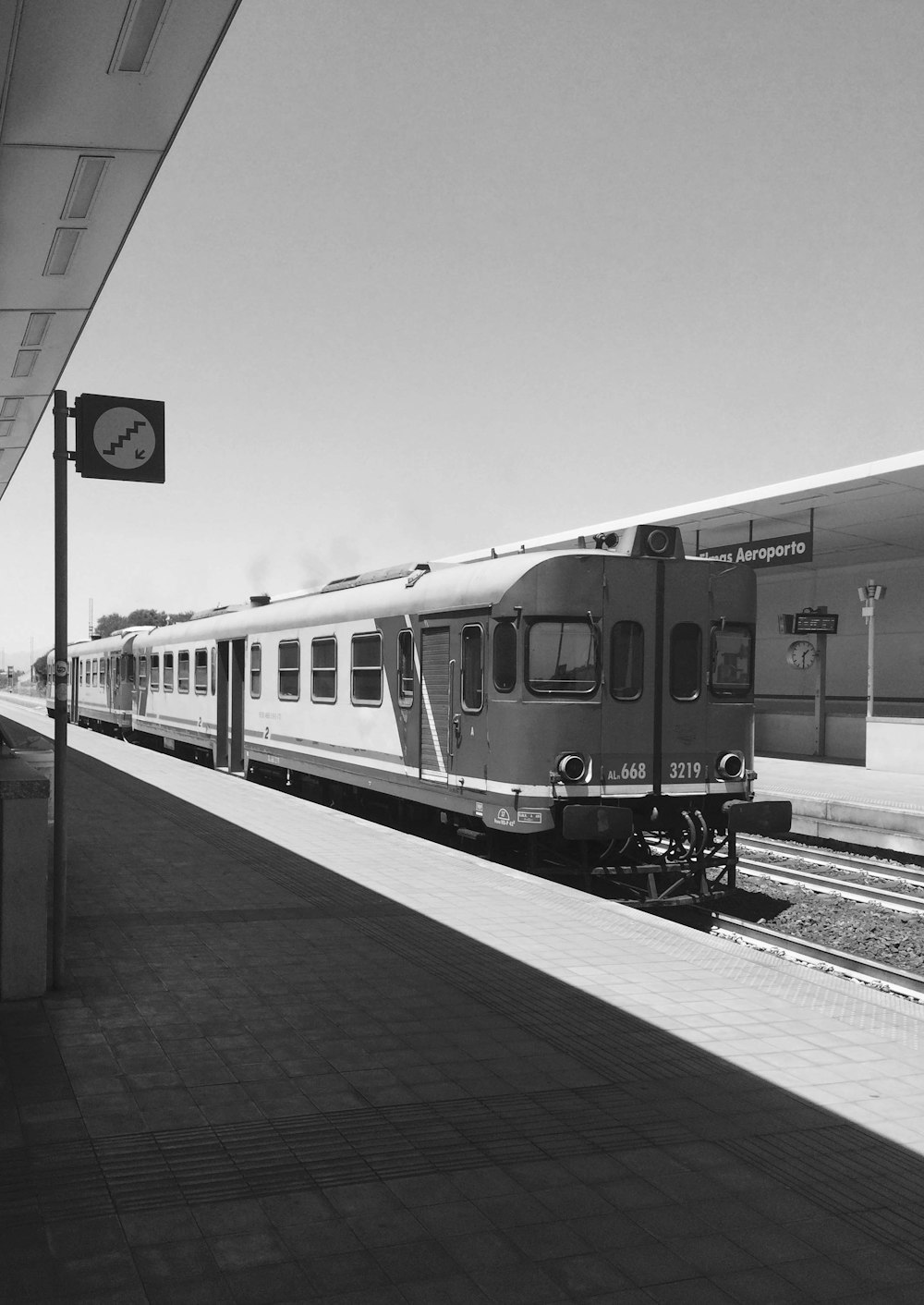 grayscale photography of train in station