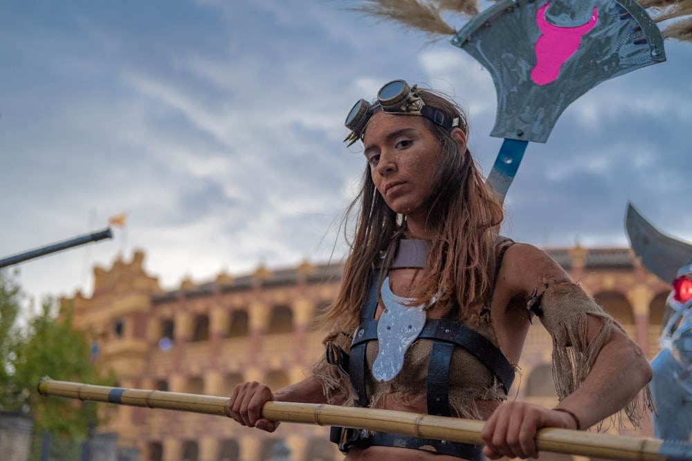 woman holding brown stick