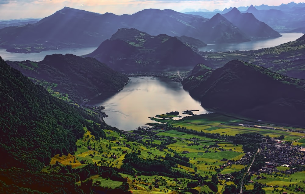 aerial photography of body of water surrounded by mountains