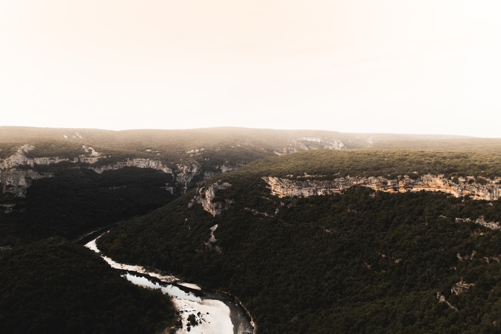 green and brown terrain under white clouds