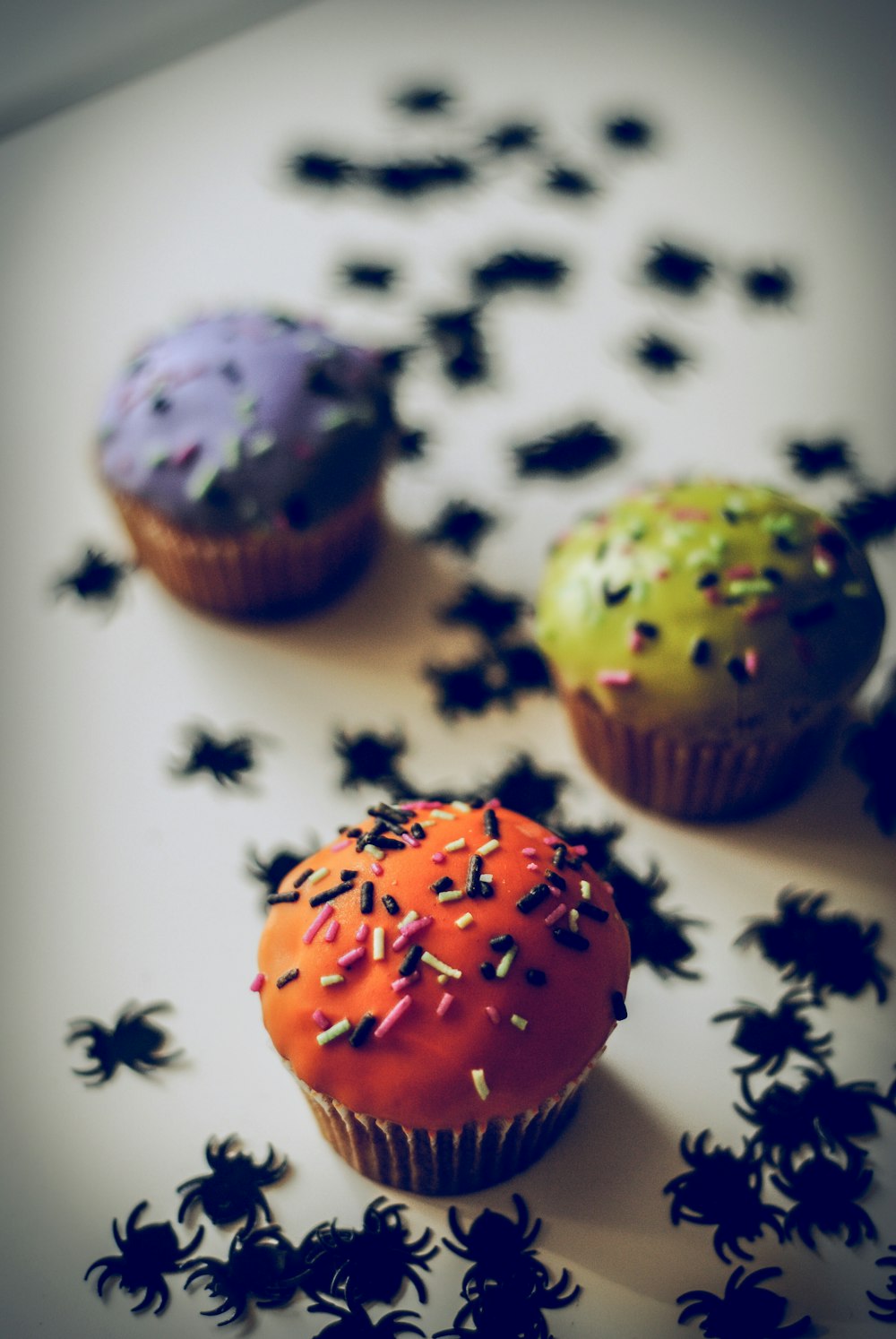 three cup cake on white surface