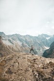 person climbing to peak on mountain scenery