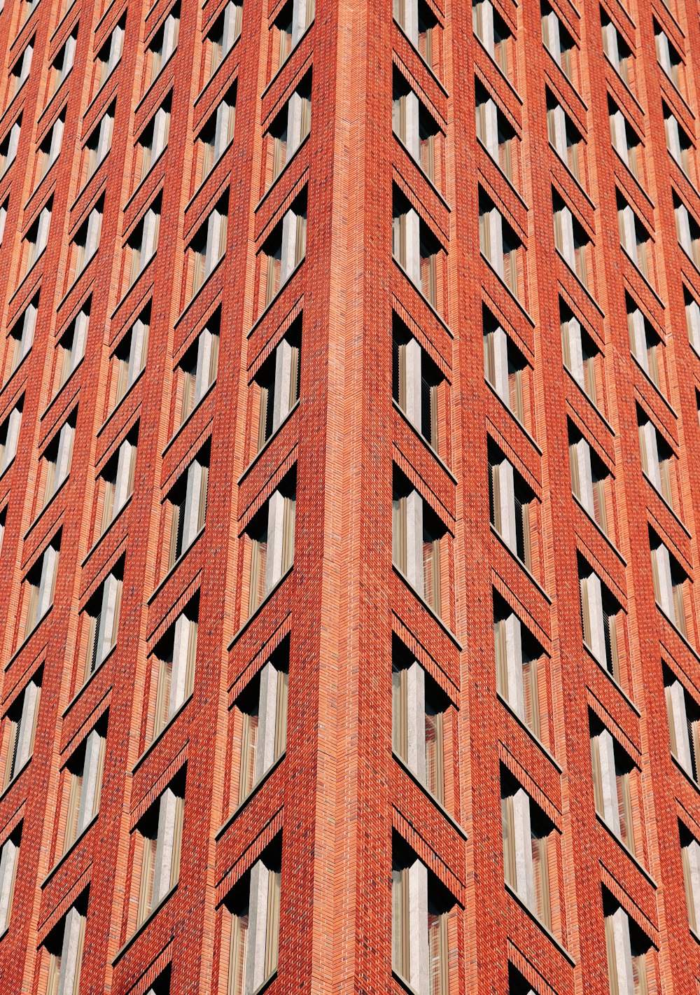 a very tall red brick building with lots of windows