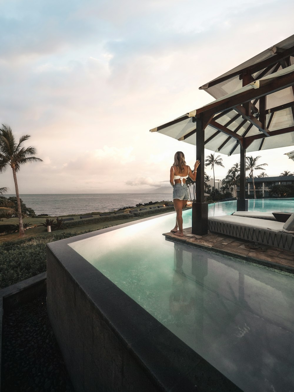 woman standing beside pool