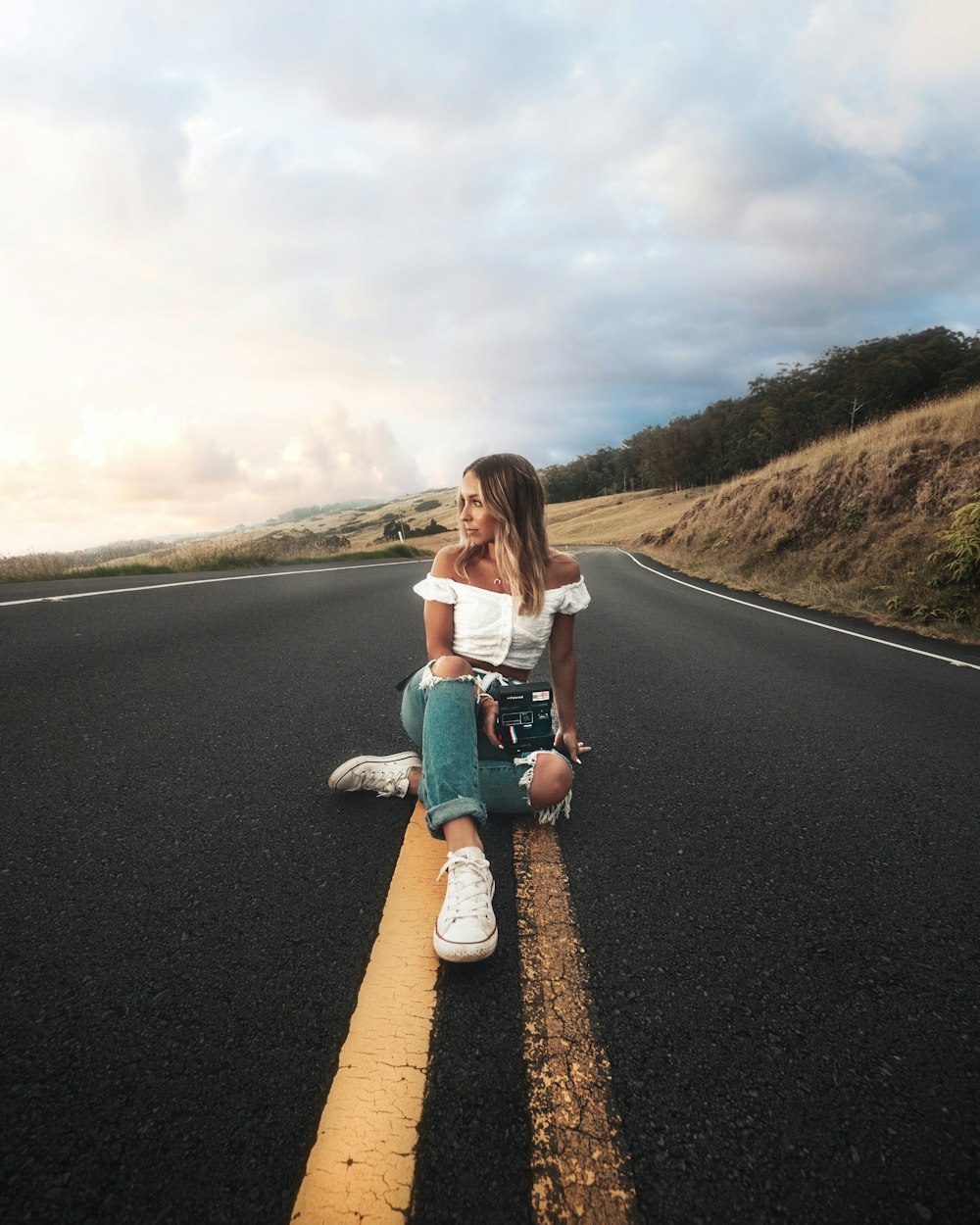woman sitting on highway