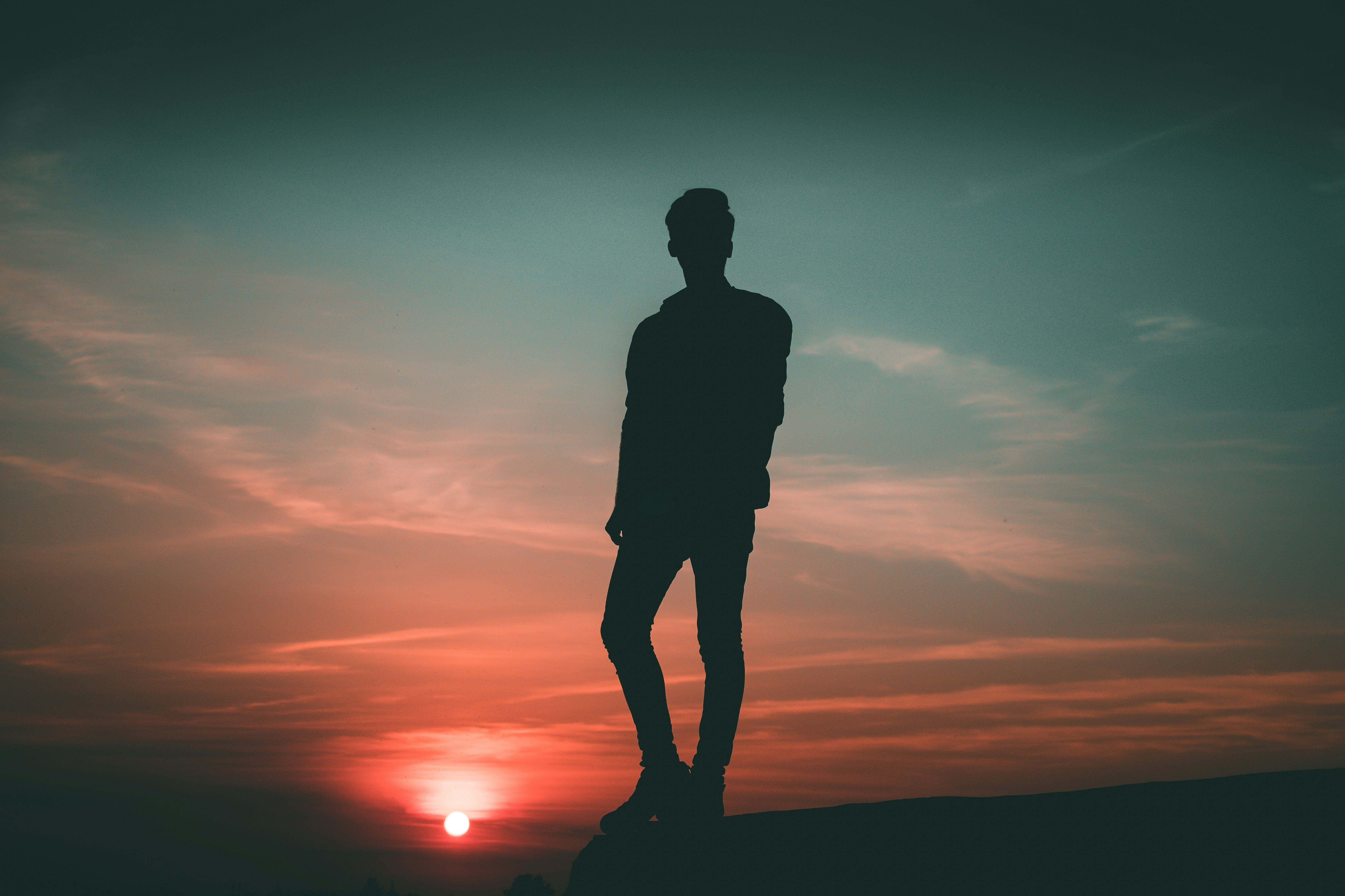 silhouette of man standing during twilight