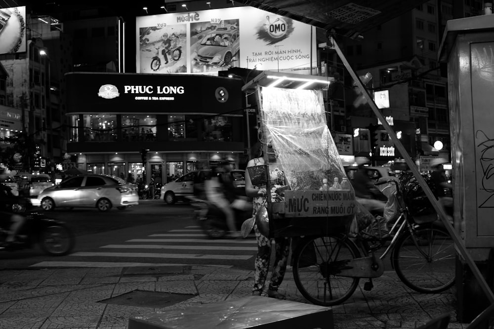 person standing beside cruiser bike parked near road