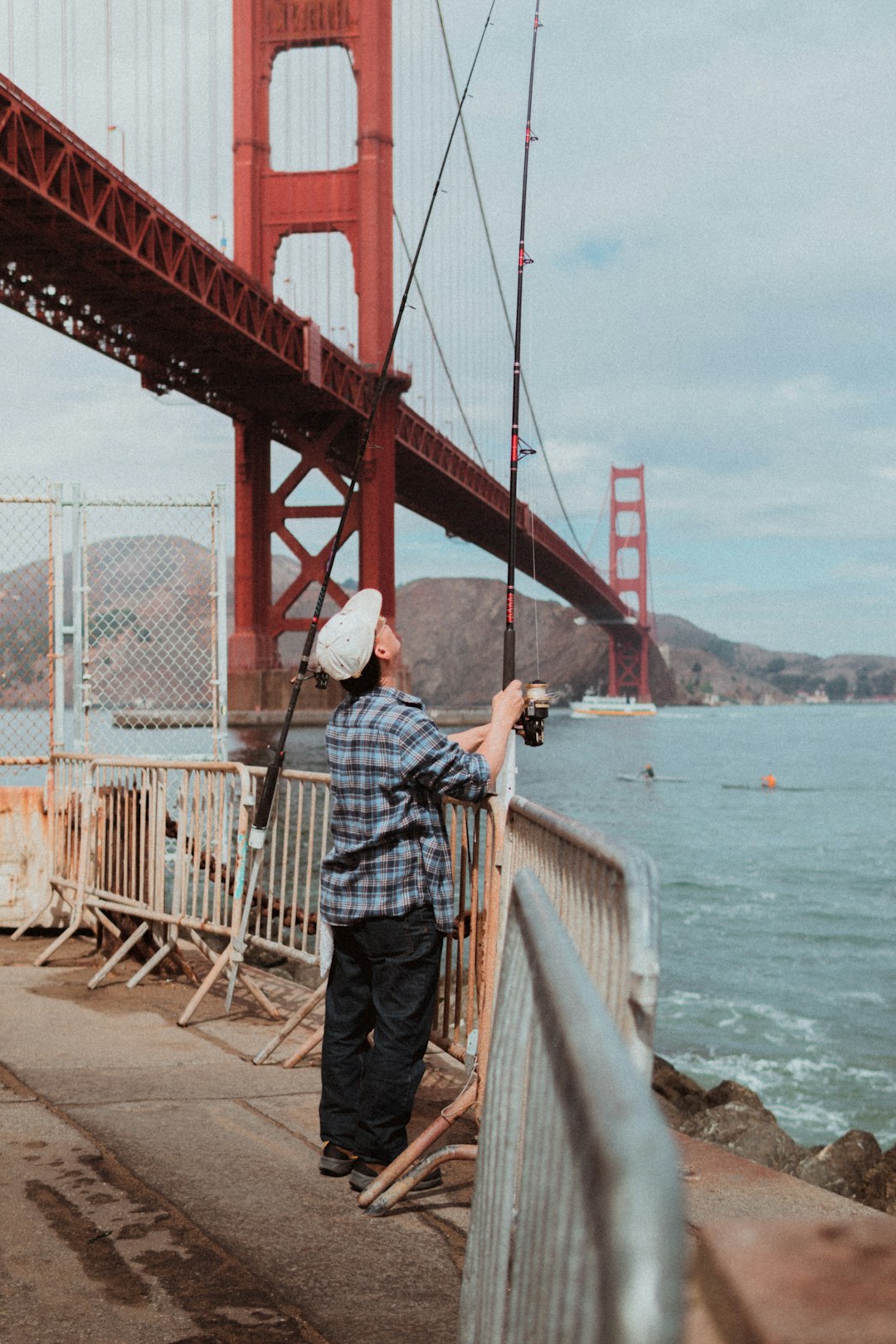 man holding black fishing rod