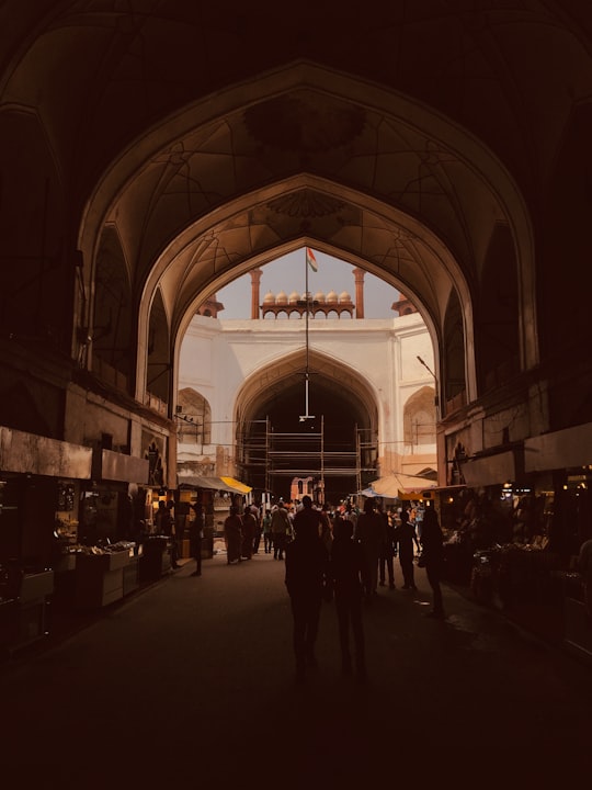 crowd walking under arch shed in Red Fort India