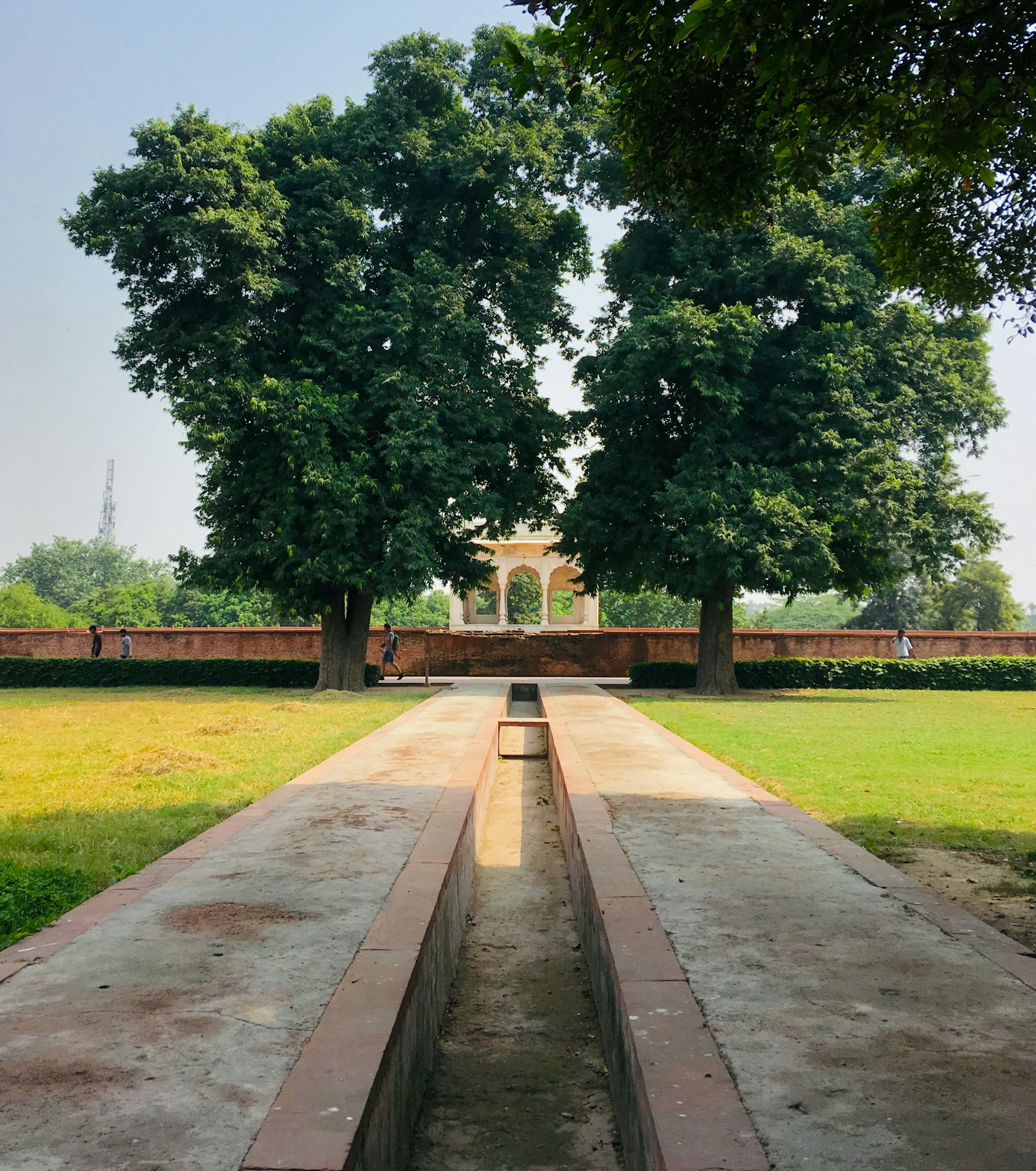 A beautifully landscaped open area with walking paths and seating spaces, reflecting the harmony of nature and design at Vastu Heritage.