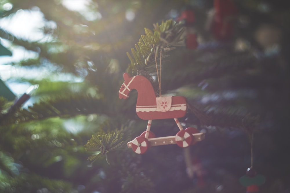 red wooden house miniature in christmas tree