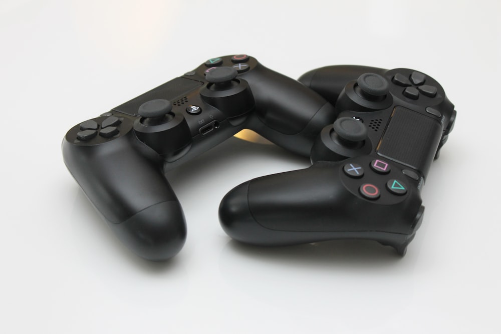 two black Sony PS4 controllers