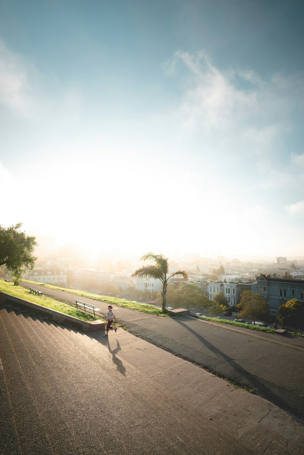 person running towards stairs during sunrise