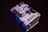 A small, thick book covered with various colorful stickers and texts, prominently featuring the word 'JESUS'. It is set against a plain dark background, enhancing the contrast of the vibrant collage on the book cover.
